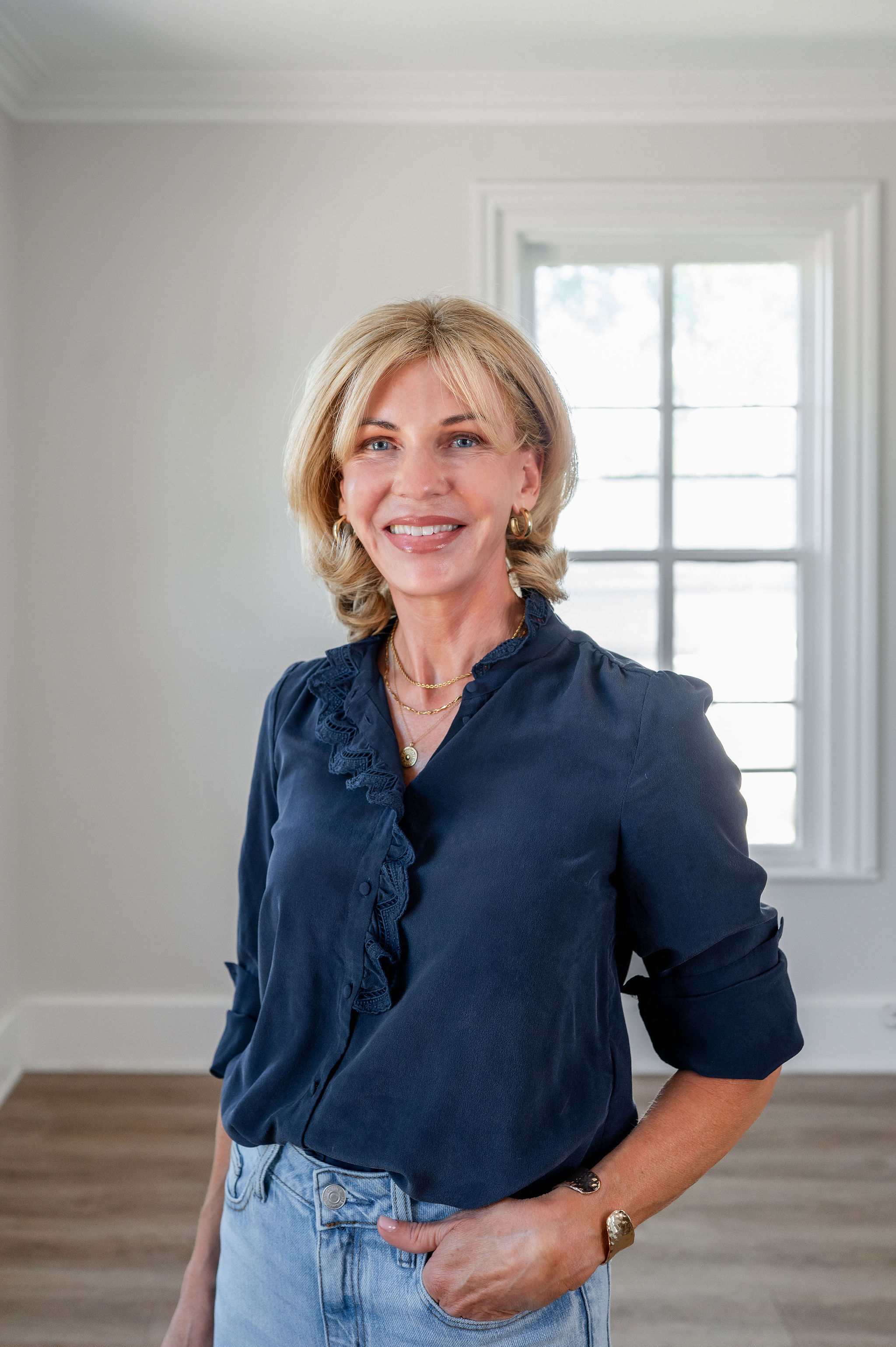 Laura Akkermans, Toronto image consultant, smiling in a navy silk blouse